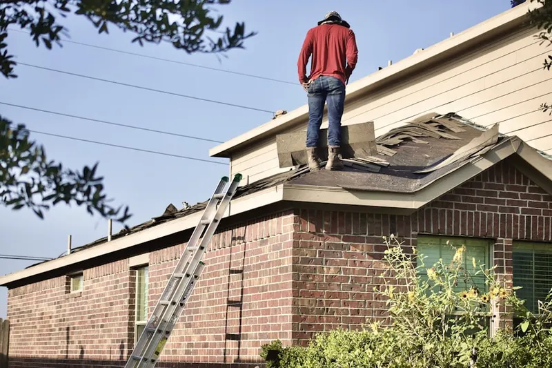 Professional roofer working on a residential roof in Cardiff